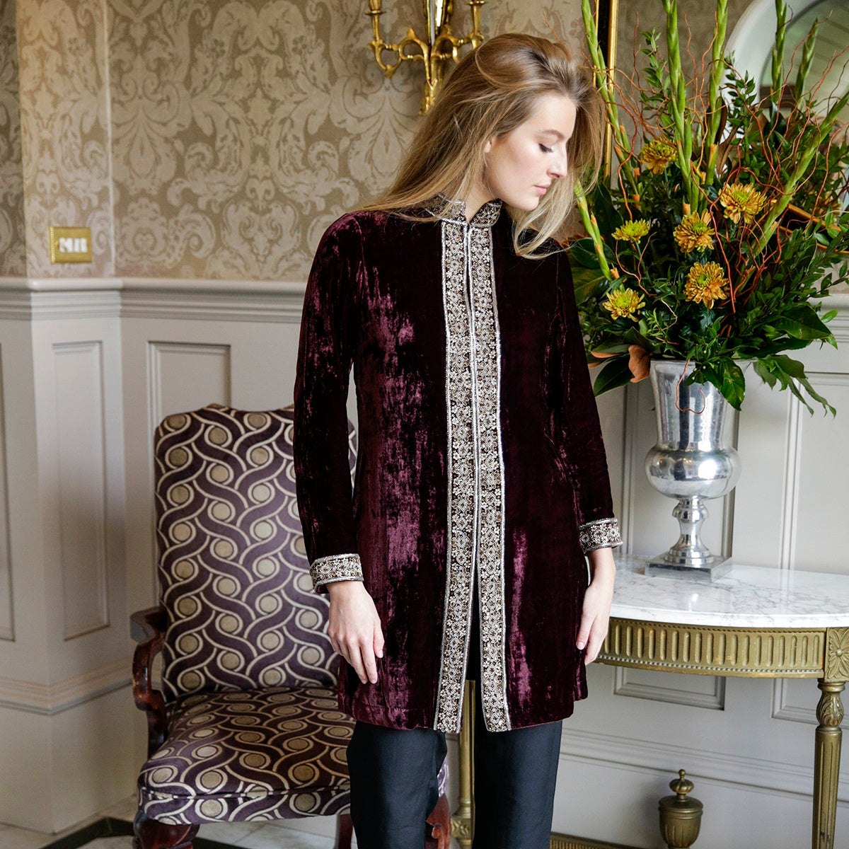Detail view of deep burgundy embroidered velvet jacket fabric by Kaminee